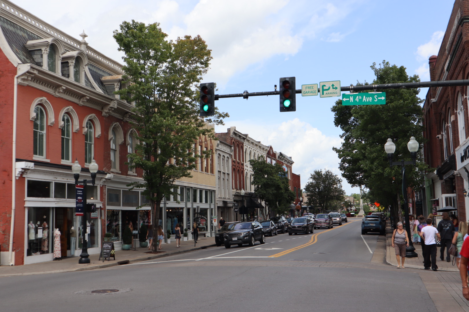 Historic brick storefronts and tree-lined sidewalks along Main Street in downtown Franklin, Tennessee